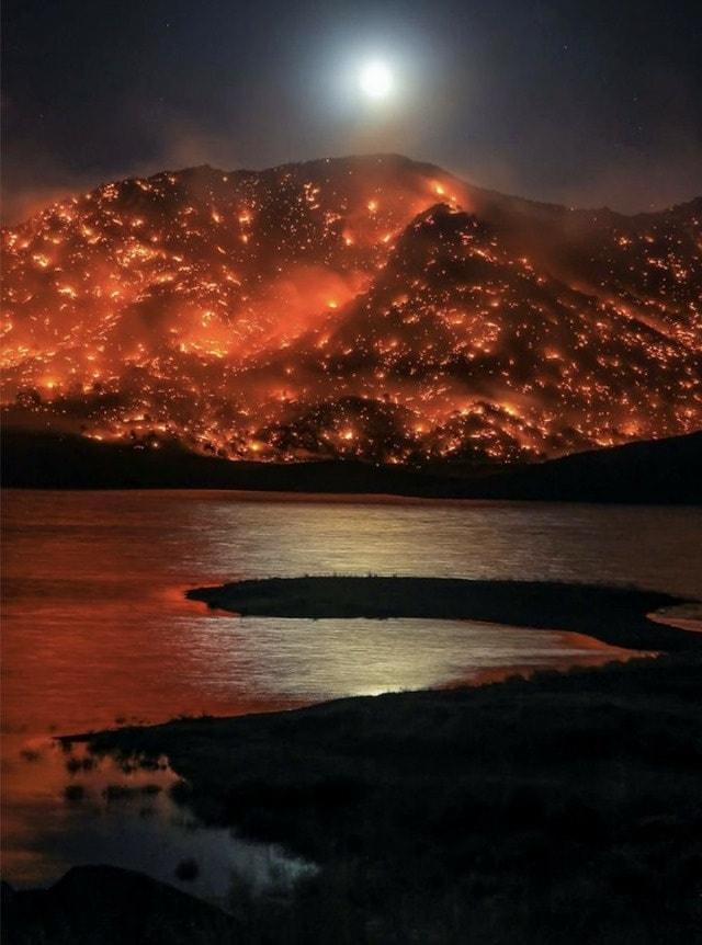 Moonrise over a Californian hill blazing with wildfire
